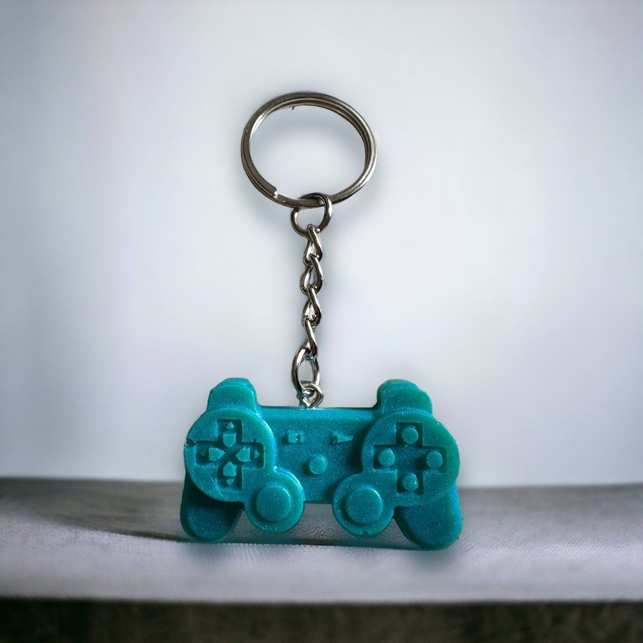 Porte clés manette de Play bleu turquoise 